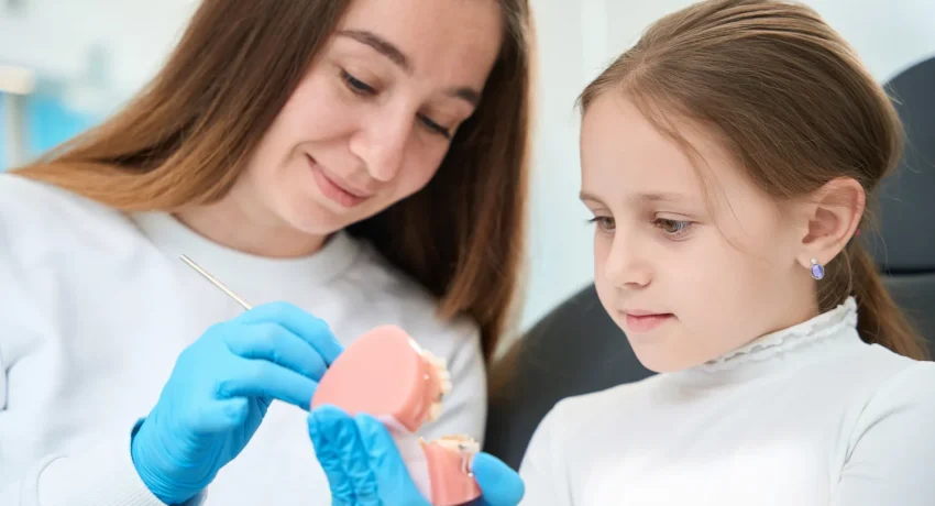 pediatric-dentist-explaining-teeth-examination-pro-2023-11-27-05-23-28-utc
